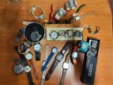 a lot of watches that are sitting on a table