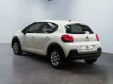 the rear of a white car is parked in a room