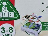 a box with a toy train set inside of it