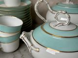 many cups and saucers that are sitting on a table