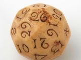 a wooden dice with numbers on it on a white surface