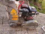 a small machine that is sitting on the side of the road
