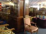 many chairs and a grandfather clock in this room