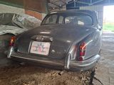 a car that is parked in a garage with a tarp on the roof