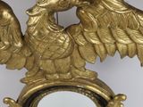 a gold clock with an eagle on it
