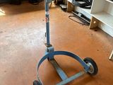 an image of a blue hand truck in a garage