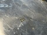a close up of a metal pan with some screws on it