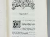 an open book with a picture of a bird and flowers on it