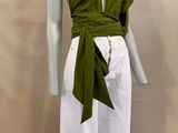 an image of a mannequin wearing a green top and white pants