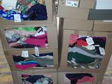 boxes of clothing are stacked on top of each other in a warehouse