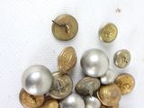 a lot of buttons that are sitting on a table