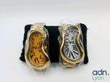 two watches sitting on top of each other on a table