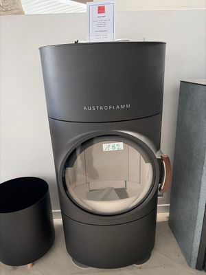 a black stove sitting next to a black trash can