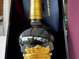 a bottle of liquor that is in a box on a table