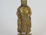 bronze statue of a woman with a hat and robe on a wooden base