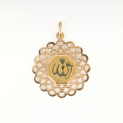 an image of a gold plated pendant with an om symbol
