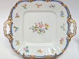 a plate with flowers on it sitting on a table