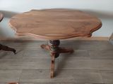 a small table with a wooden top on a wooden floor
