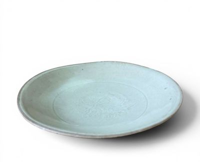 a white plate with a blue rim on a white surface