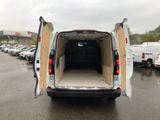 a white van with its doors open in a parking lot