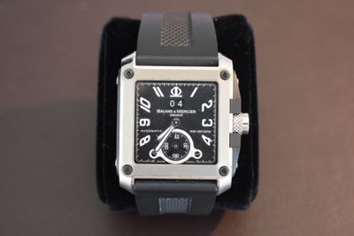 a black and silver watch with a black band