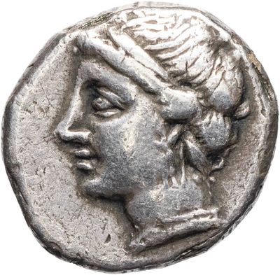 a silver coin with a woman ' s face on it