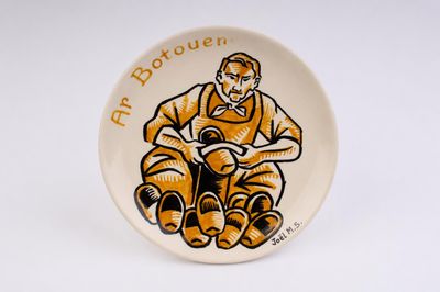 a plate with a picture of a man sitting on a chair
