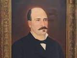 portrait of a man with a moustache in a suit and bow tie