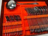 a tray with silverware and spoons in it on a table