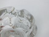 a glass bowl that has some coins inside of it