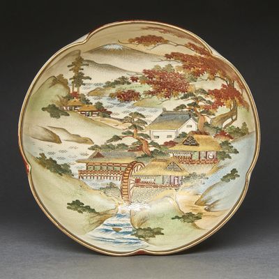 a plate with a painting on it on a table