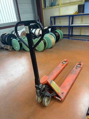 a fork lifter sitting on the floor in a warehouse