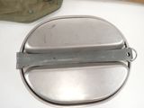 a metal container with a handle on a table