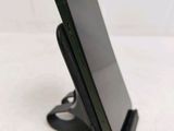 a cell phone that is sitting on top of a stand