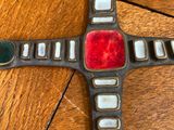 an image of a cross made out of glass and metal on a wooden table