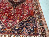 a rug on the floor with a cat sitting on it