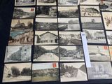 a lot of old photos on display on a table