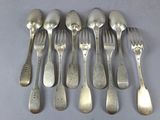 a lot of silver spoons and forks on a table