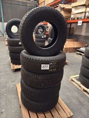 tires are stacked on pallets in a warehouse with pallets of pallets