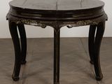 a black table with a wooden top on a tiled floor