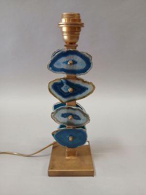 a blue and gold table lamp with a gold base