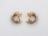 a pair of gold hoop earrings on a white background