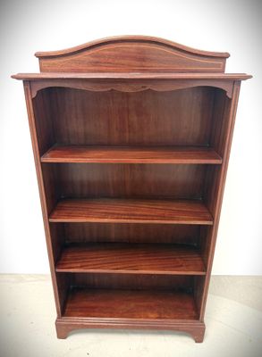 an old wooden bookcase with three shelves on top of it