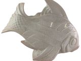 a white ceramic fish statue on a white background