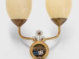 pair of brass wall lights with glass shades on a white background
