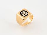 a gold ring with a black and white logo on it