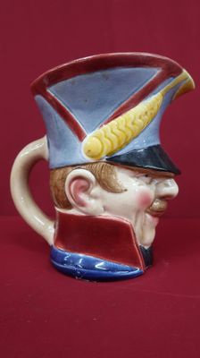 a ceramic mug with a soldier ' s head on it