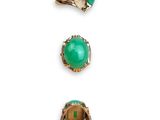 a set of three rings and a ring with a green stone