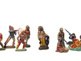 five figurines of native americans on a white background