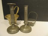 two candles that are sitting on a table next to a basket